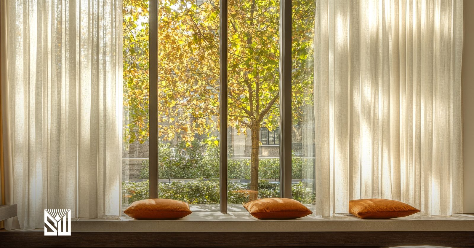 Sunlit lounge with sheer curtains and warm cushions